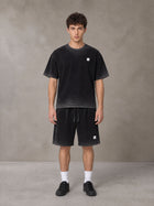 Model wearing the SM Sig. Reverse Dyed T-shirt and SM Sig. Reverse Dyed Shorts in Midnight Black, front view.
