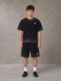 Model wearing the SM Sig. Reverse Dyed T-shirt and SM Sig. Reverse Dyed Shorts in Midnight Black, front view.