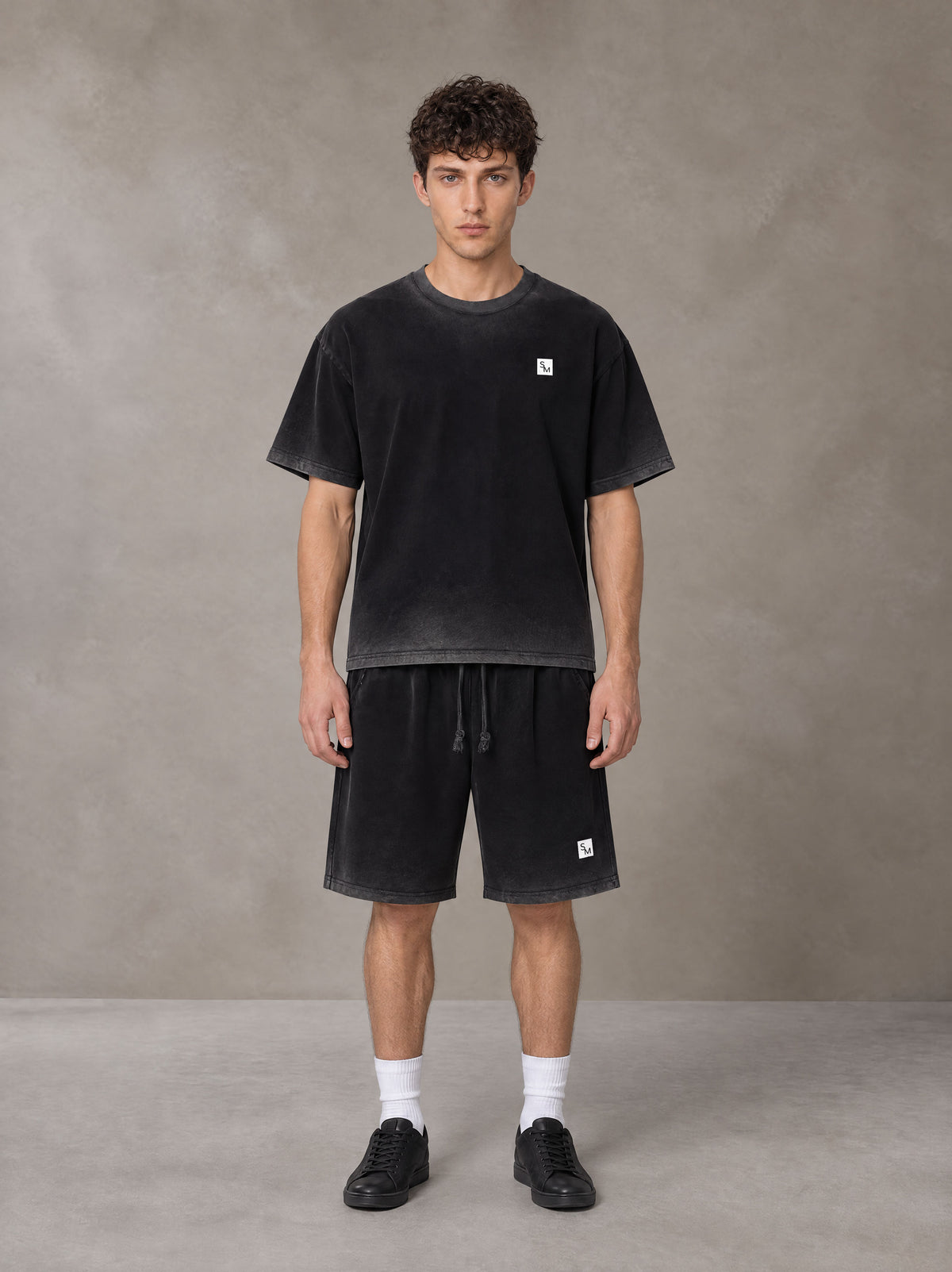 Model wearing the SM Sig. Reverse Dyed T-shirt and SM Sig. Reverse Dyed Shorts in Midnight Black, front view.