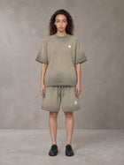Model wearing the SM Sig. Reverse Dyed T-shirt and SM Sig. Reverse Dyed Shorts in Stone Grey, front view.