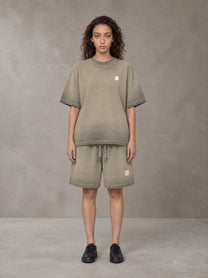 Model wearing the SM Sig. Reverse Dyed T-shirt and SM Sig. Reverse Dyed Shorts in Stone Grey, front view.