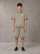 Model wearing the SM Sig. Reverse Dyed T-shirt and SM Sig. Reverse Dyed Shorts in Stone Grey, front view.