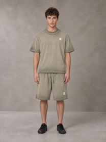 Model wearing the SM Sig. Reverse Dyed T-shirt and SM Sig. Reverse Dyed Shorts in Stone Grey, front view.