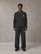 Model wearing the SM Sig. Snow Line Sweatshirt and SM Sig. Snow Line Sweatpants in Midnight Black, front view.