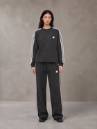 Model wearing the SM Sig. Snow Line Sweatshirt and SM Sig. Snow Line Sweatpants in Midnight Black, front view.