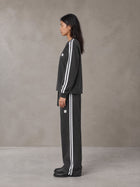 Model wearing the SM Sig. Snow Line Sweatshirt and SM Sig. Snow Line Sweatpants in Midnight Black, side profile.