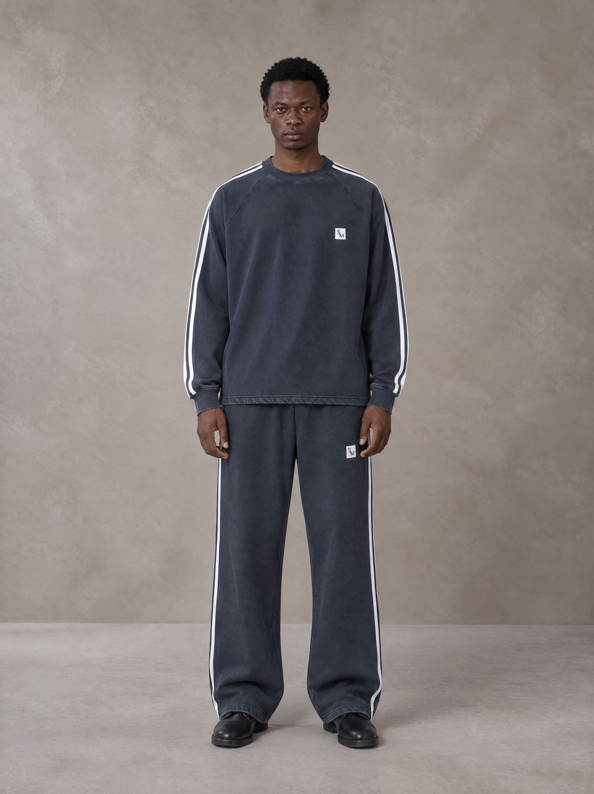 Model wearing the SM Sig. Snow Line Sweatshirt and SM Sig. Snow Line Sweatpants in Oxford Navy, front view.