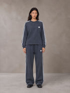 Model wearing the SM Sig. Snow Line Sweatshirt and SM Sig. Snow Line Sweatpants in Oxford Navy, front view.