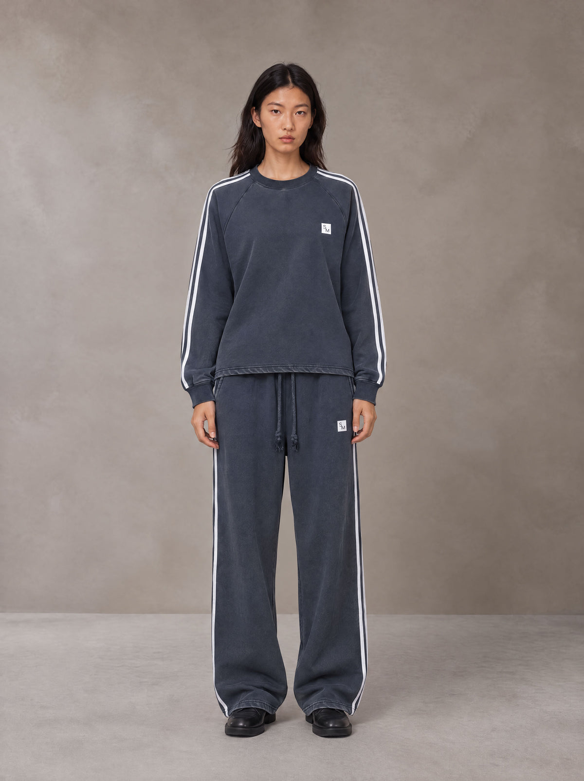 Model wearing the SM Sig. Snow Line Sweatshirt and SM Sig. Snow Line Sweatpants in Oxford Navy, front view.