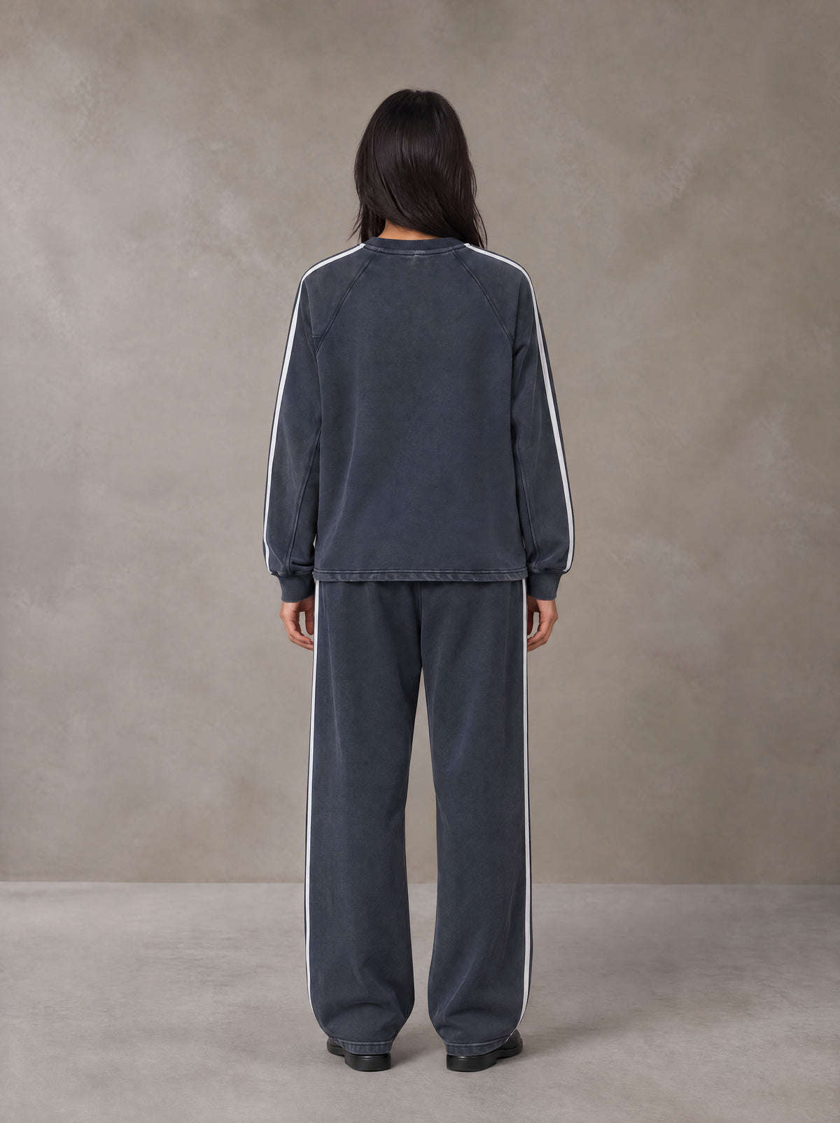 Model wearing the SM Sig. Snow Line Sweatshirt and SM Sig. Snow Line Sweatpants in Oxford Navy, rear view.