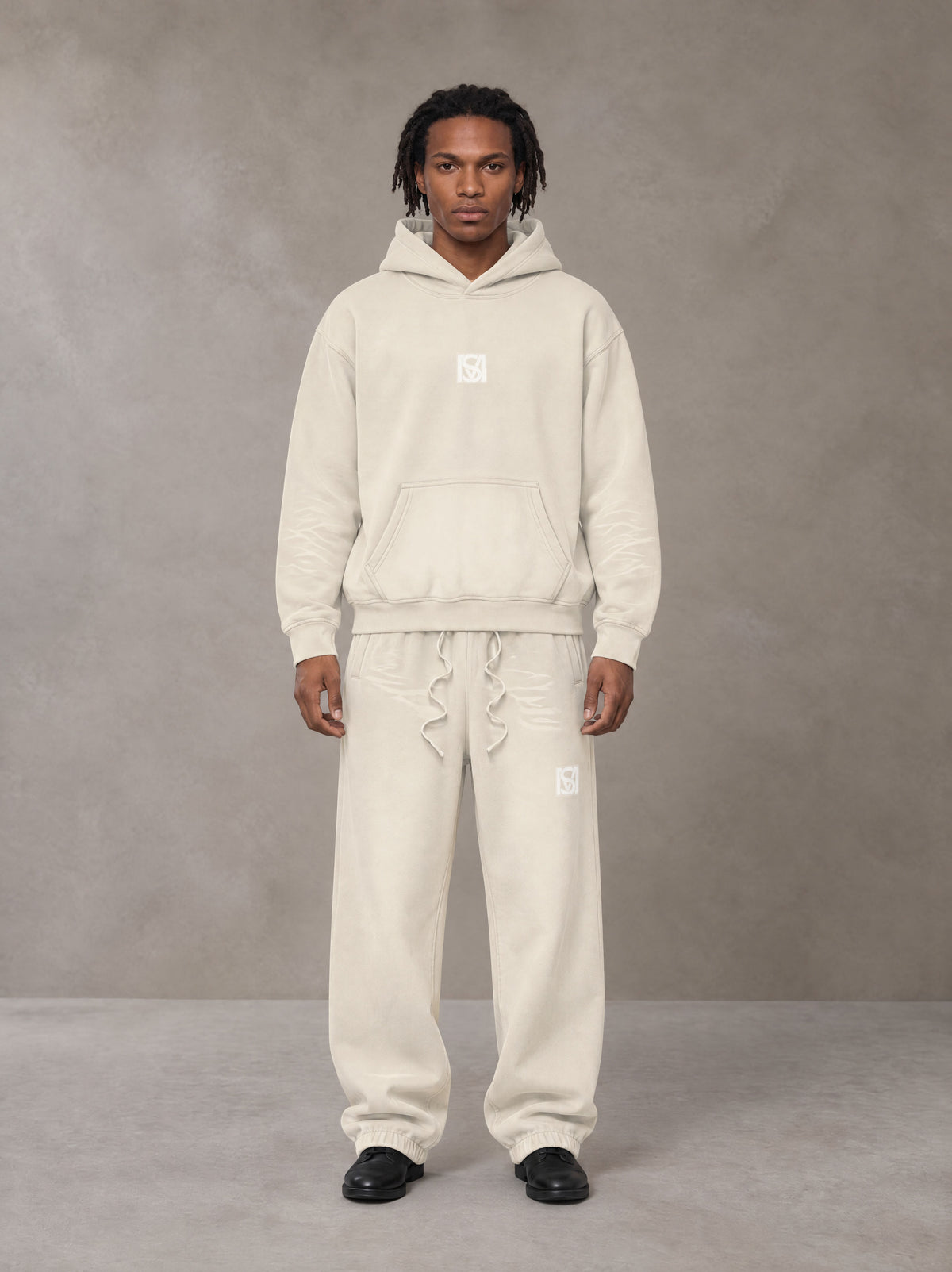 Model wearing the SM Sunfade Fleeced Hoodie and SM Sunfade Fleeced Sweatpants in Camel Tan, front view.