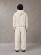 Model wearing the SM Sunfade Fleeced Hoodie and SM Sunfade Fleeced Sweatpants in Camel Tan, rear view.