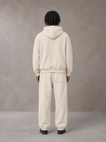 Model wearing the SM Sunfade Fleeced Hoodie and SM Sunfade Fleeced Sweatpants in Camel Tan, rear view.