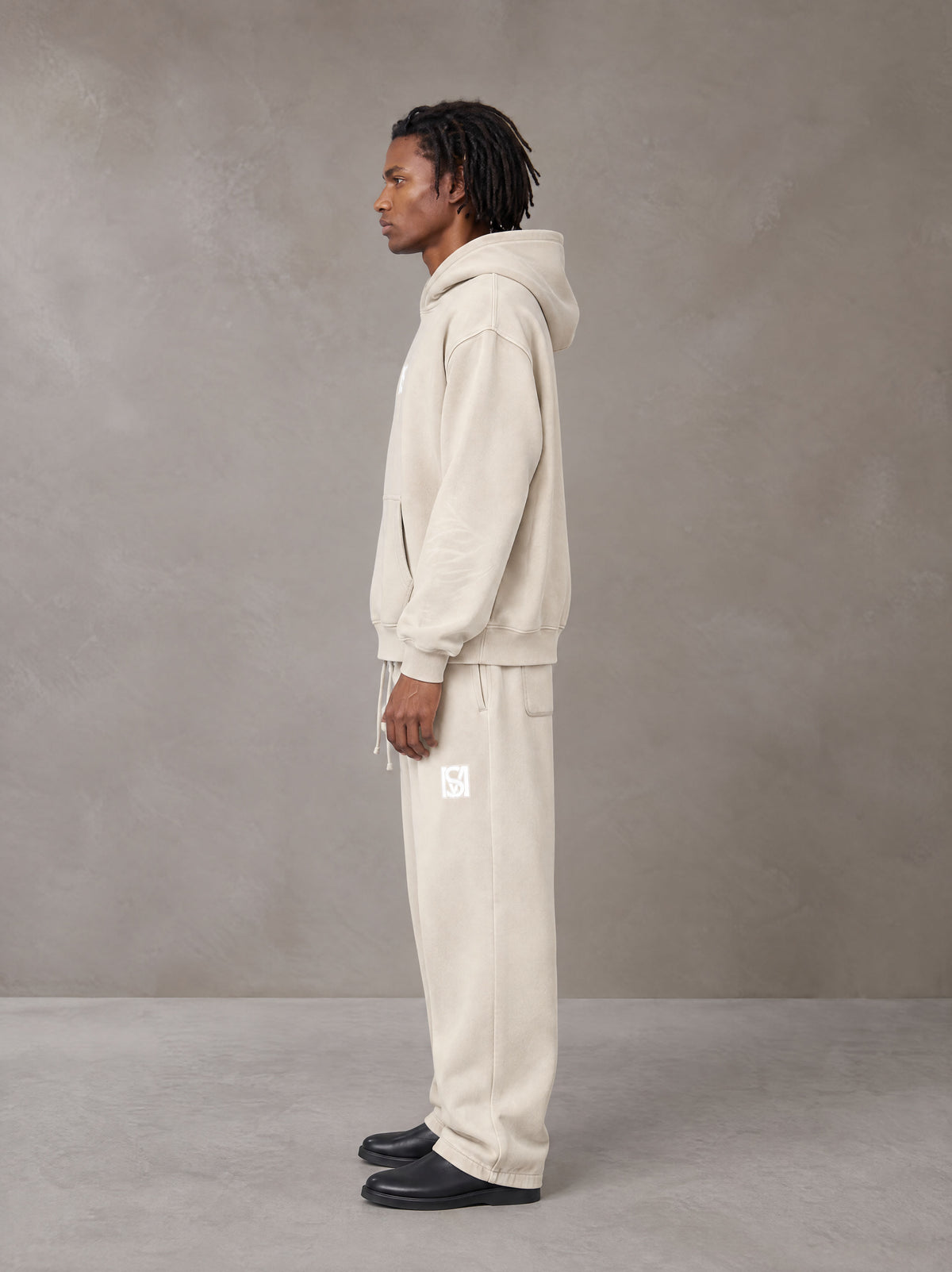 Model wearing the SM Sunfade Fleeced Hoodie and SM Sunfade Fleeced Sweatpants in Camel Tan, side profile.