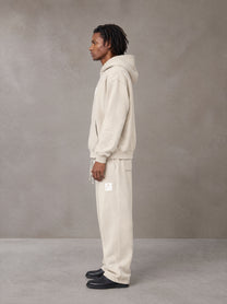 Model wearing the SM Sunfade Fleeced Hoodie and SM Sunfade Fleeced Sweatpants in Camel Tan, side profile.