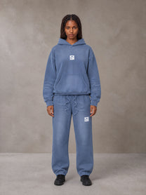 Model wearing the SM Sunfade Fleeced Hoodie and SM Sunfade Fleeced Sweatpants in Deep Denim, front view.