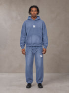 Model wearing the SM Sunfade Fleeced Hoodie and SM Sunfade Fleeced Sweatpants in Deep Denim, front view.