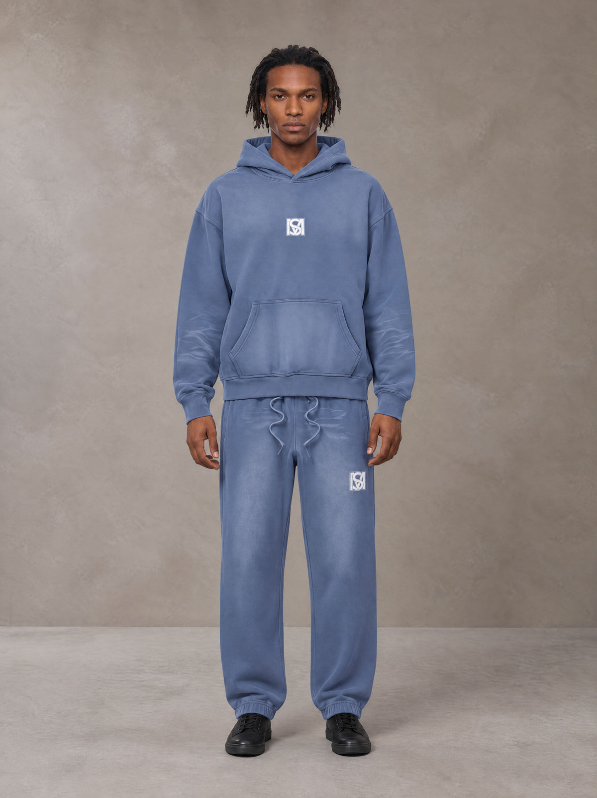 Model wearing the SM Sunfade Fleeced Hoodie and SM Sunfade Fleeced Sweatpants in Deep Denim, front view.