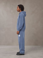 Model wearing the SM Sunfade Fleeced Hoodie and SM Sunfade Fleeced Sweatpants in Deep Denim, side profile.