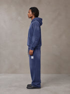 Model wearing the SM Sunfade Fleeced Hoodie and SM Sunfade Fleeced Sweatpants in Oxford Navy, side profile.