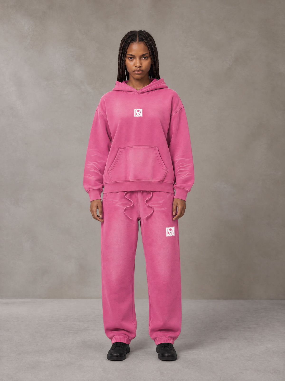 Model wearing the SM Sunfade Fleeced Hoodie and SM Sunfade Fleeced Sweatpants in Vivid Pink, front view.