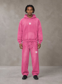 Model wearing the SM Sunfade Fleeced Hoodie and SM Sunfade Fleeced Sweatpants in Vivid Pink, front view.