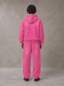 Model wearing the SM Sunfade Fleeced Hoodie and SM Sunfade Fleeced Sweatpants in Vivid Pink, rear view.