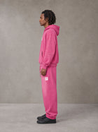 Model wearing the SM Sunfade Fleeced Hoodie and SM Sunfade Fleeced Sweatpants in Vivid Pink, side profile.