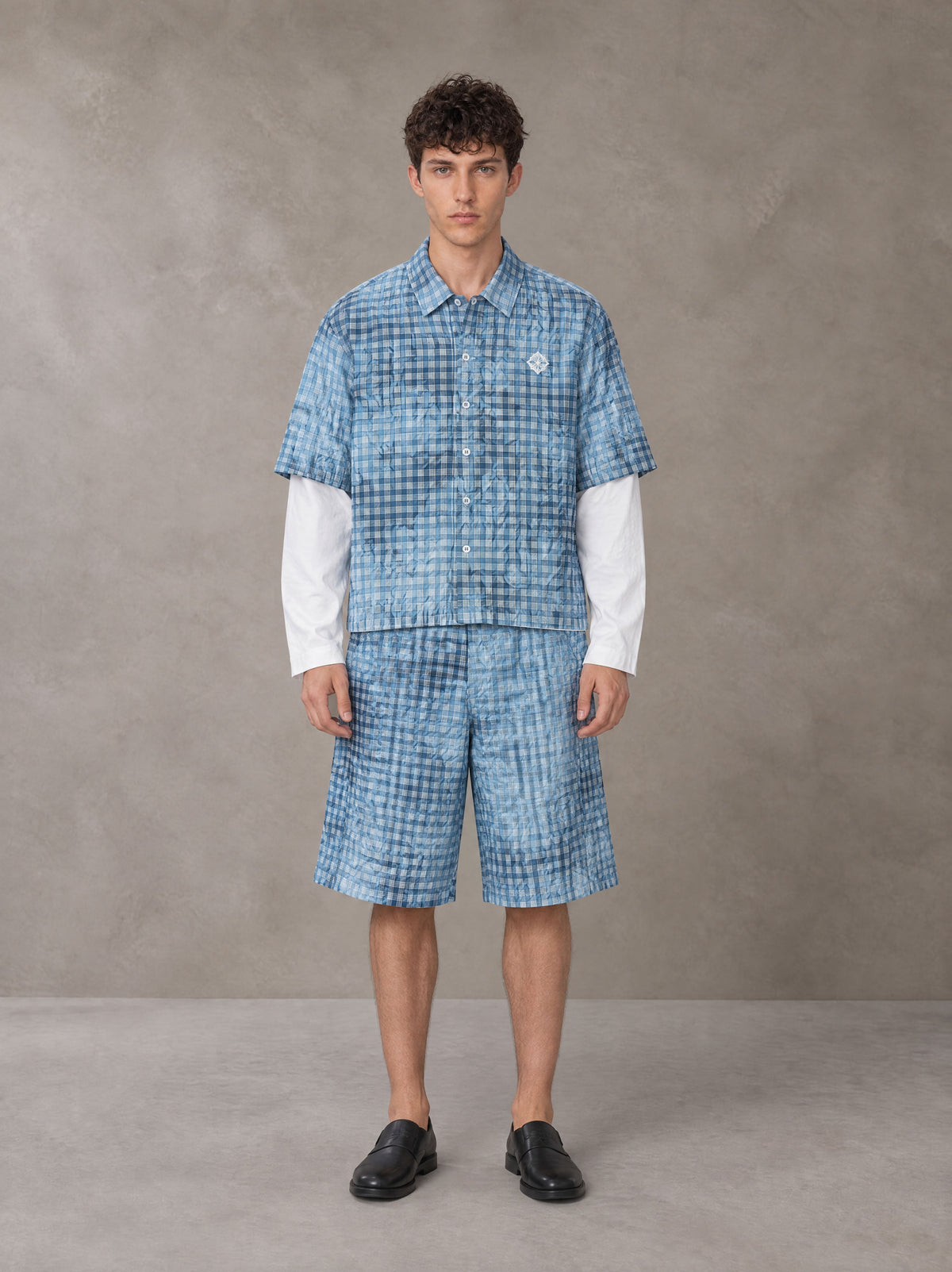 Model wearing the SM Eternal Fleur Mirage Shirt and SM Eternal Fleur Mirage Shorts in Mist, front view.