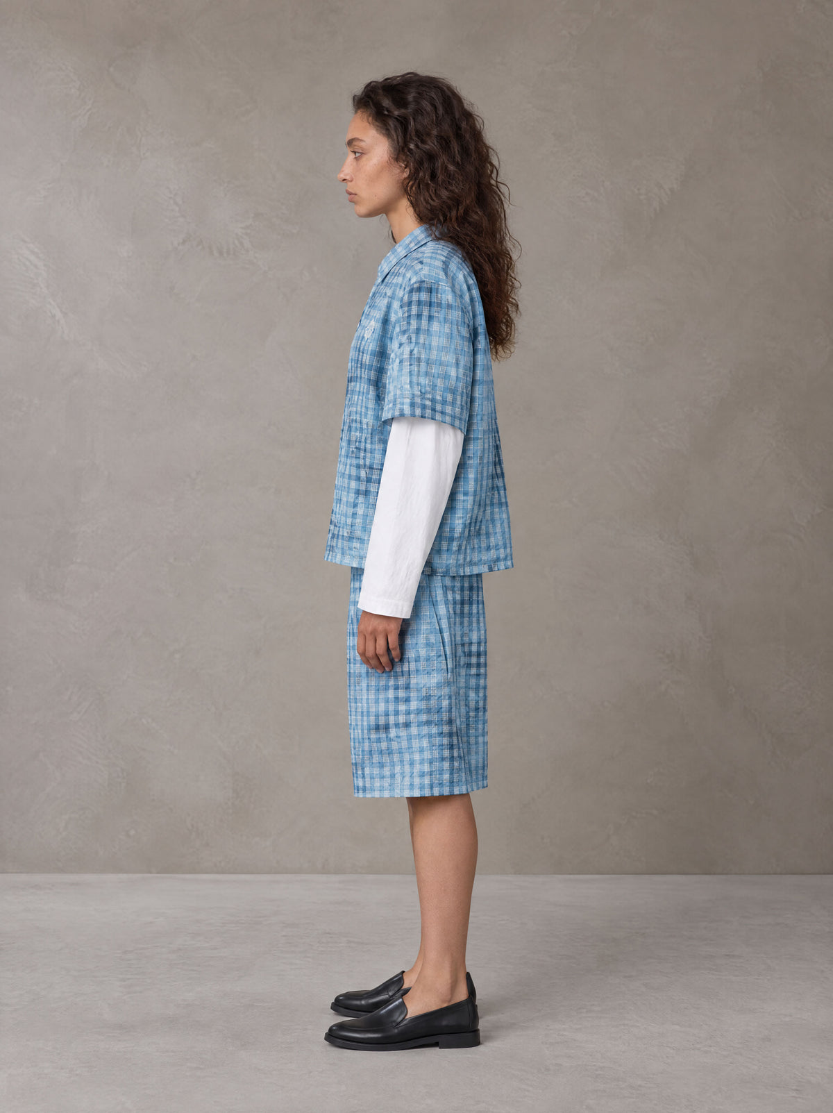 Model wearing the SM Eternal Fleur Mirage Shirt and SM Eternal Fleur Mirage Shorts in Mist, side profile.