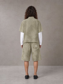 Model wearing the SM Eternal Fleur Mirage Shirt and SM Eternal Fleur Mirage Shorts in Moss, rear view.
