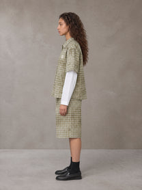 Model wearing the SM Eternal Fleur Mirage Shirt and SM Eternal Fleur Mirage Shorts in Moss, side profile.