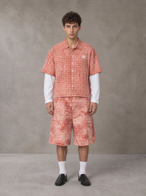 Model wearing the SM Eternal Fleur Mirage Shirt and SM Eternal Fleur Mirage Shorts in Persimmon, front view.