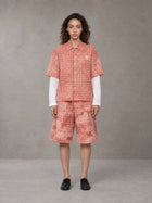 Model wearing the SM Eternal Fleur Mirage Shirt and SM Eternal Fleur Mirage Shorts in Persimmon, front view.