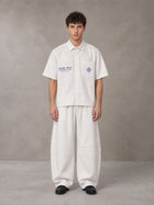 Model wearing the SM The Fabric Of Self Shirt and SM The Fabric Of Self Trousers in Ivory White, front view.