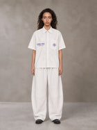 Model wearing the SM The Fabric Of Self Shirt and SM The Fabric Of Self Trousers in Ivory White, front view.