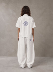 Model wearing the SM The Fabric Of Self Shirt and SM The Fabric Of Self Trousers in Ivory White, rear view.