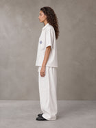 Model wearing the SM The Fabric Of Self Shirt and SM The Fabric Of Self Trousers in Ivory White, side profile.