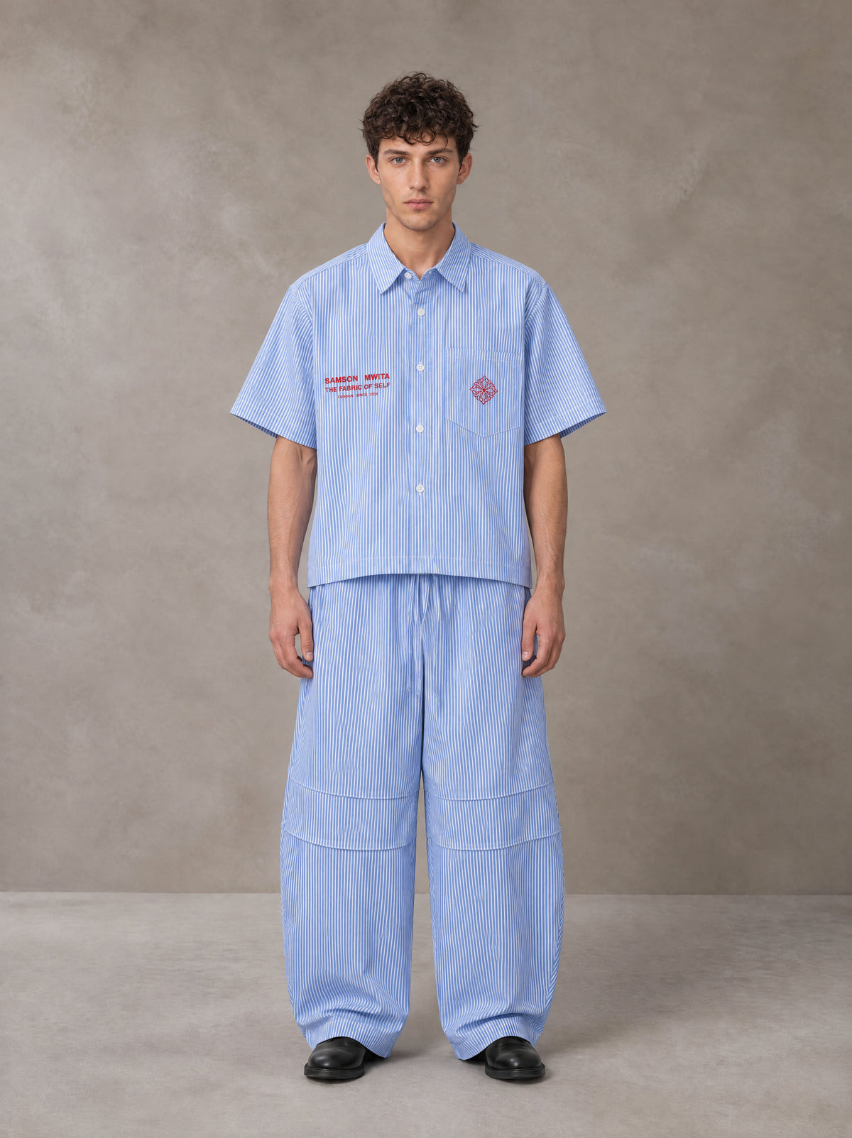 Model wearing the SM The Fabric Of Self Shirt and SM The Fabric Of Self Trousers in Rock Slate Blue, front view.