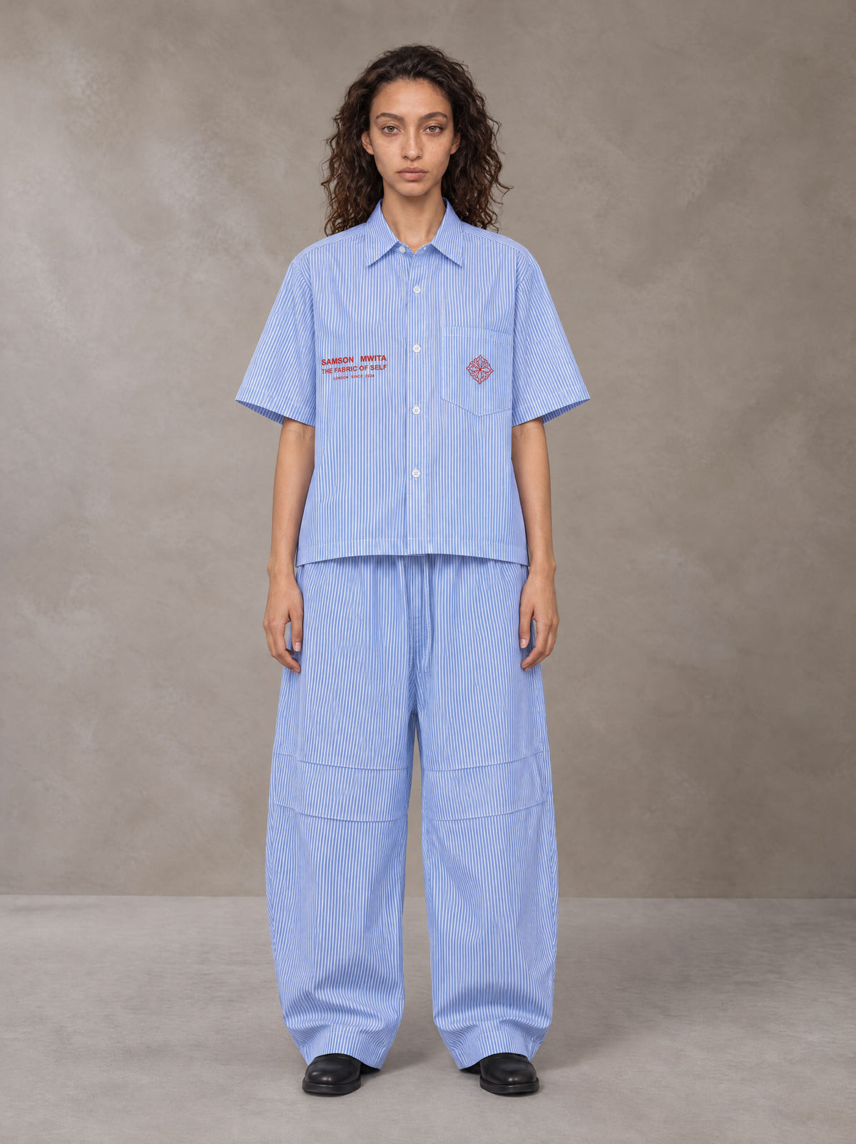 Model wearing the SM The Fabric Of Self Shirt and SM The Fabric Of Self Trousers in Rock Slate Blue, front view.