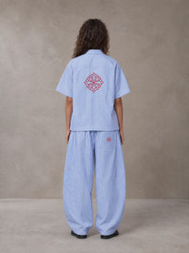 Model wearing the SM The Fabric Of Self Shirt and SM The Fabric Of Self Trousers in Rock Slate Blue, rear view.