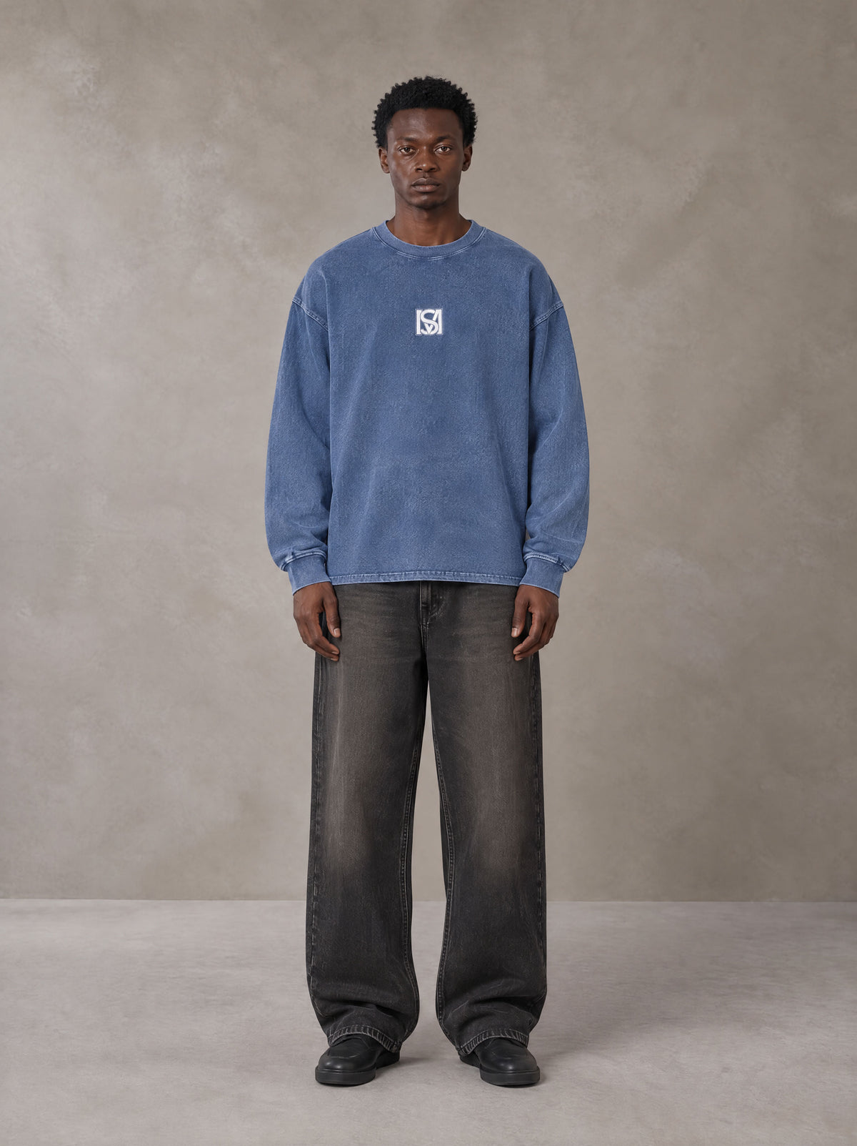 Model wearing the SM Acid Wash Long Sleeve T-shirt in Chambray, front view.