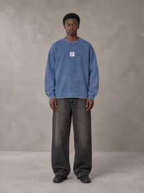 Model wearing the SM Acid Wash Long Sleeve T-shirt in Chambray, front view.