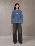 Model wearing the SM Acid Wash Long Sleeve T-shirt in Chambray, front view.