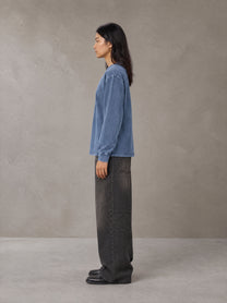 Model wearing the SM Acid Wash Long Sleeve T-shirt in Chambray, side profile.