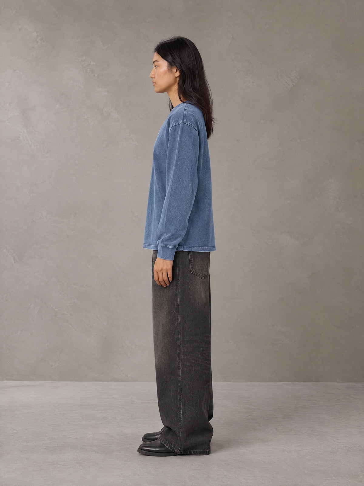 Model wearing the SM Acid Wash Long Sleeve T-shirt in Chambray, side profile.