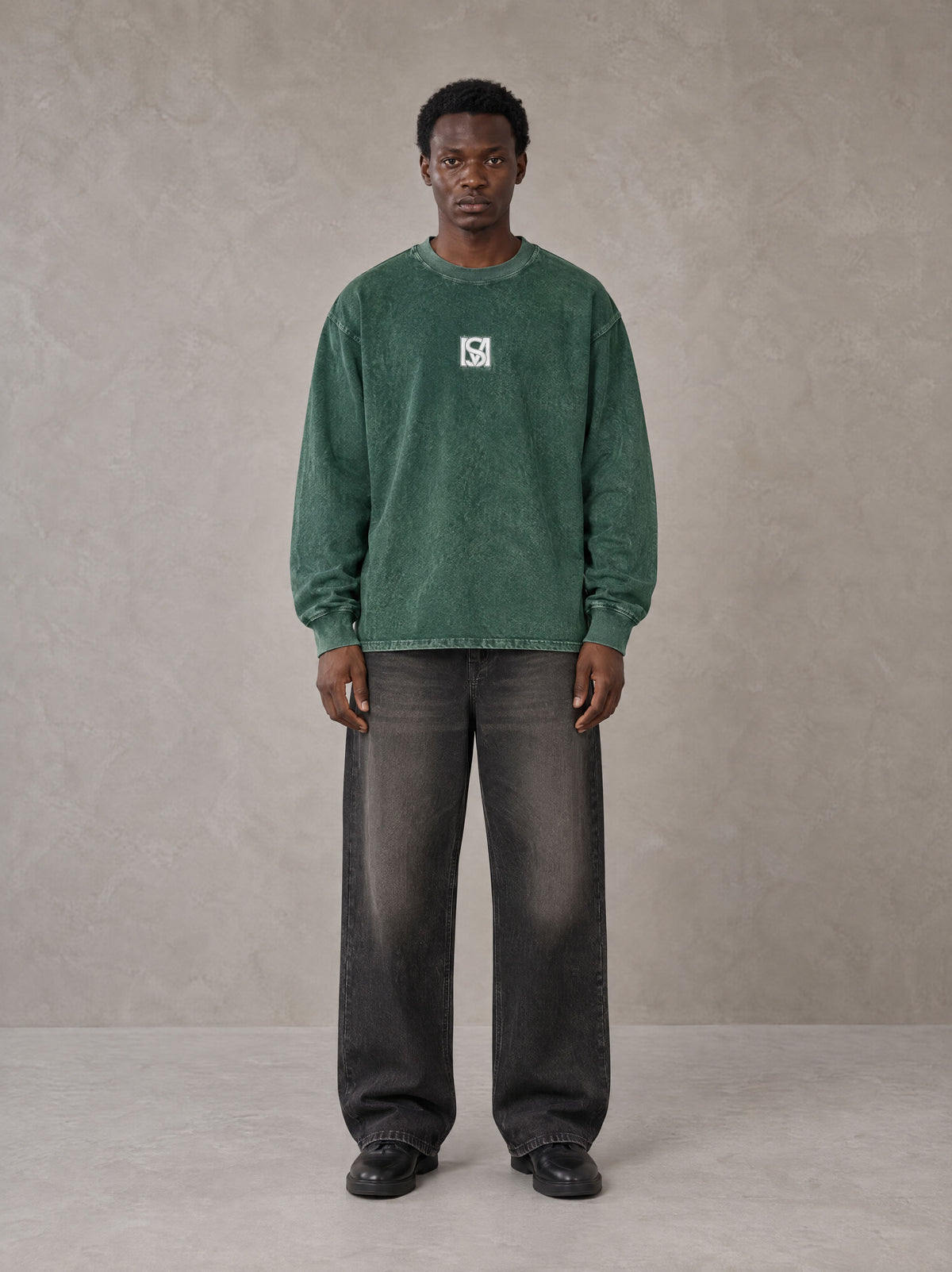 Model wearing the SM Acid Wash Long Sleeve T-shirt in Dark Green, front view.