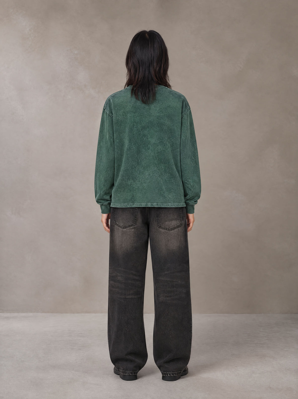 Model wearing the SM Acid Wash Long Sleeve T-shirt in Dark Green, rear view.