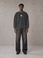 Model wearing the SM Acid Wash Long Sleeve T-shirt in Deep Charcoal, front view.