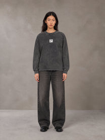 Model wearing the SM Acid Wash Long Sleeve T-shirt in Deep Charcoal, front view.
